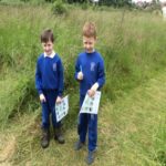 two pupils with a key diagram looking at nature