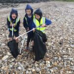 pupil on a litter pick at the seaside