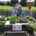 pupils standing in front of school grown produce from the garden