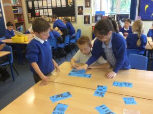 classroom pupils at desks looking at diagrams