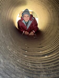 pupil posing and smiling in a large tunnel
