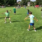 pupils playing with hula hoops on sports day